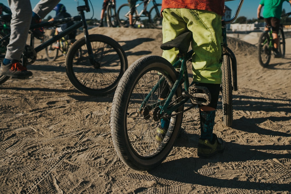 person in green shorts riding bike