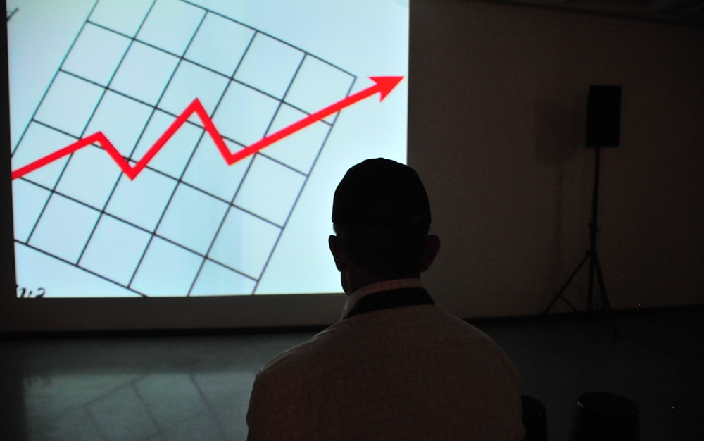 a person watching a presentation of a graph
