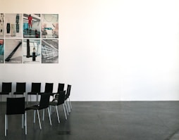 black chairs beside wall