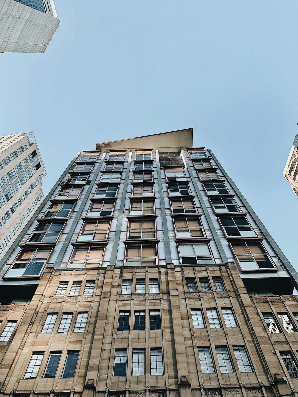 low-angle photography of brown building under clear sky