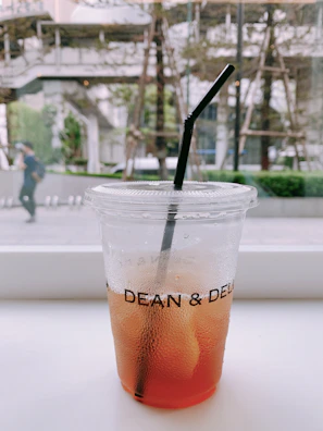 The cup tent cool.me wrapped around a glass of iced tea, beads of condensation forming on the outside.