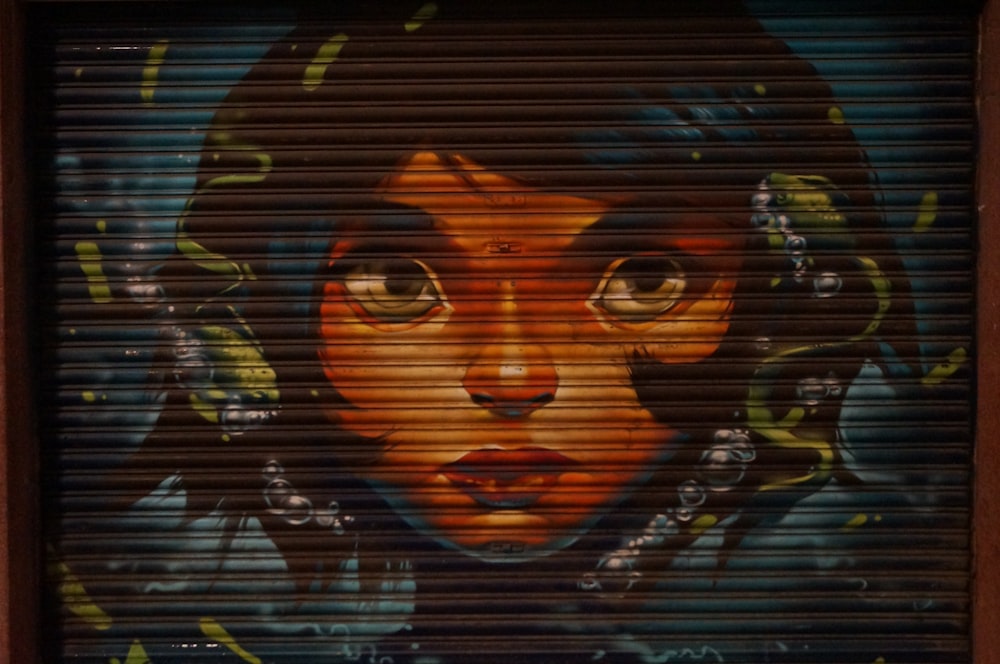female cartoon character face printed on closed roller shutter