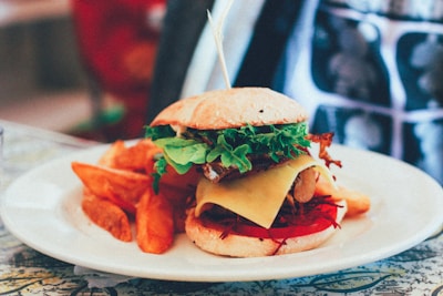 A close-up of a gourmet burger with fresh ingredients and a side of crispy fries.