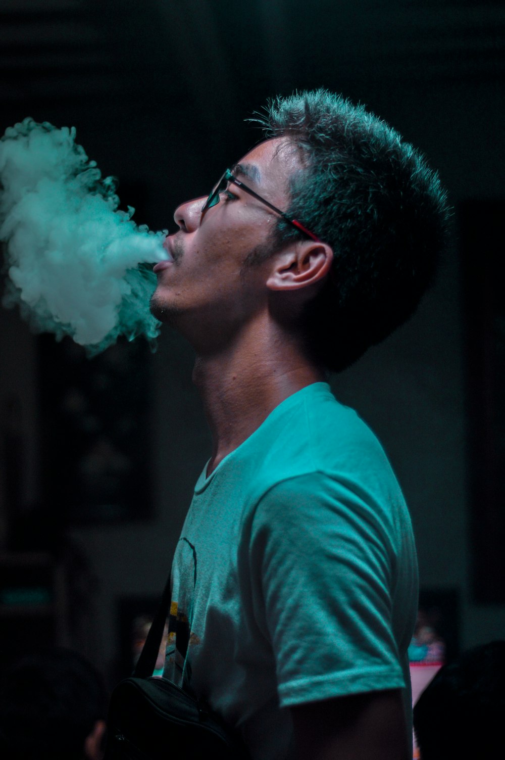 man in white shirt smoking