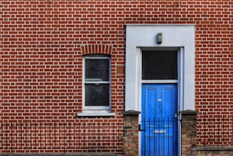 red brick building with closed door and window