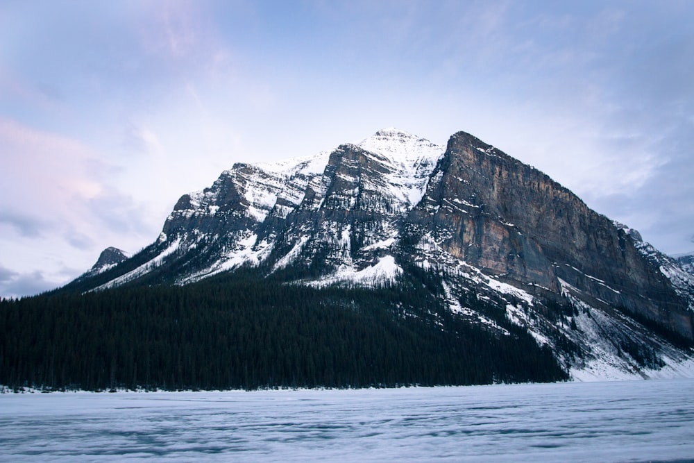 brown and white mountain under white clouds