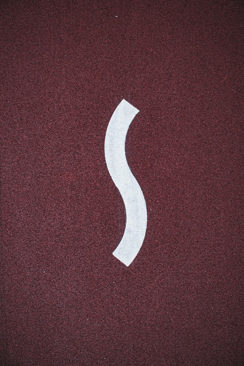 a picture of a white letter s on a red surface