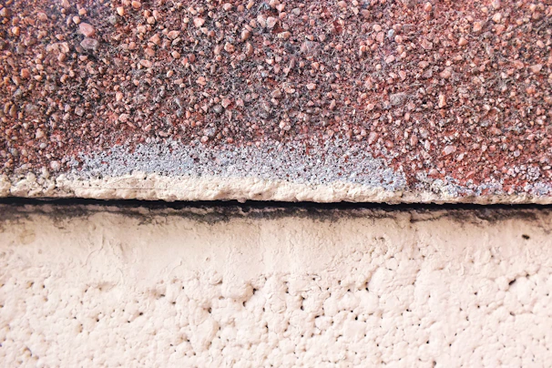 Close-up of a deep ripe crimson plaster finish highlighting the texture of the island pebble surface.