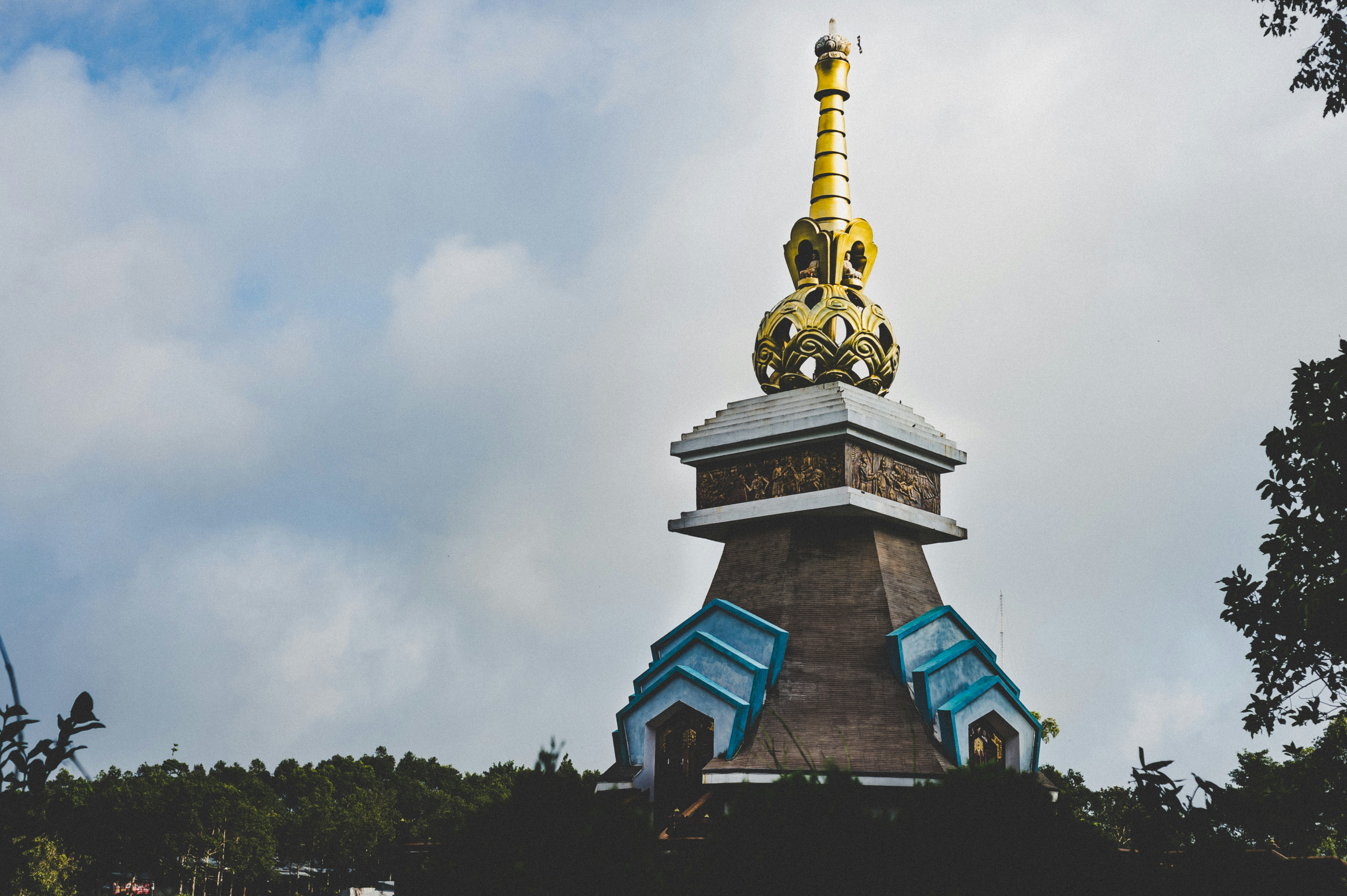 brown building under cloudy sky during daytime