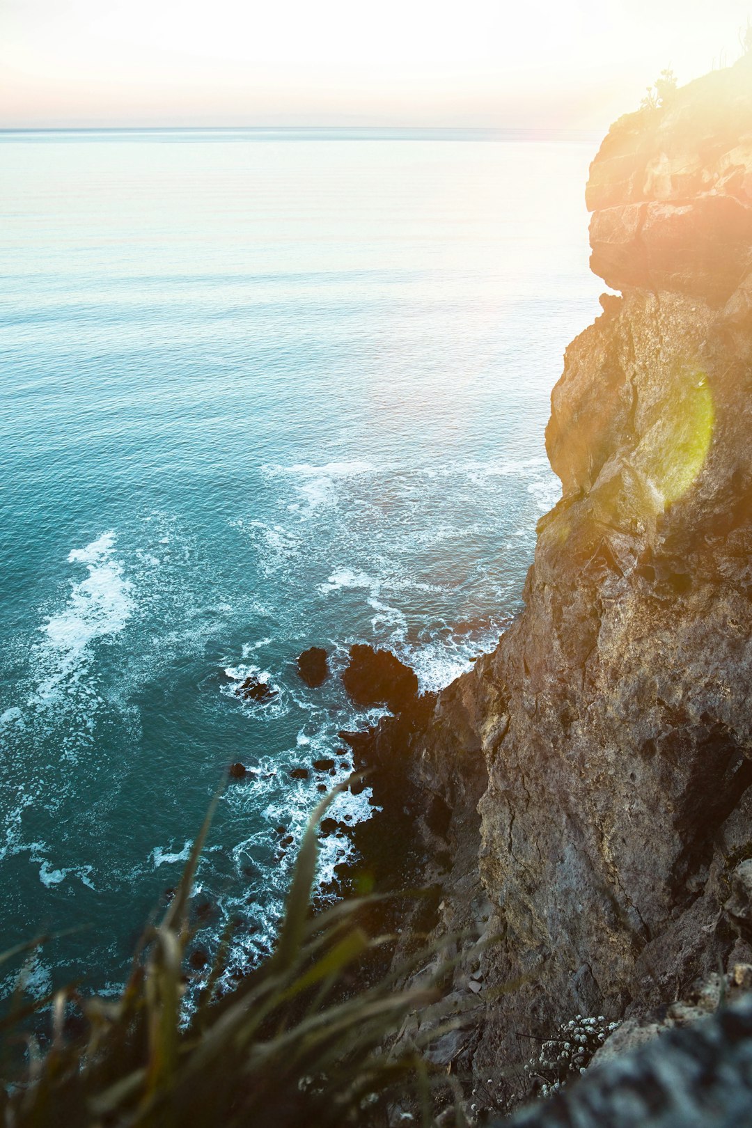 rock formation beside sea at daytime