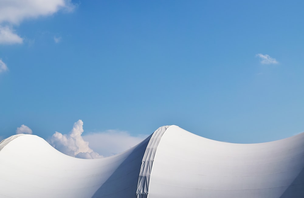 a large white structure with a sky background