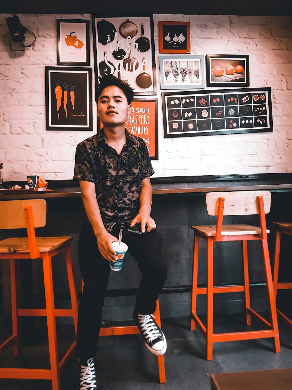 a man sitting at a bar with a drink in his hand