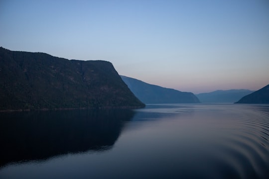 body of water and mountains during day in Flam Norway