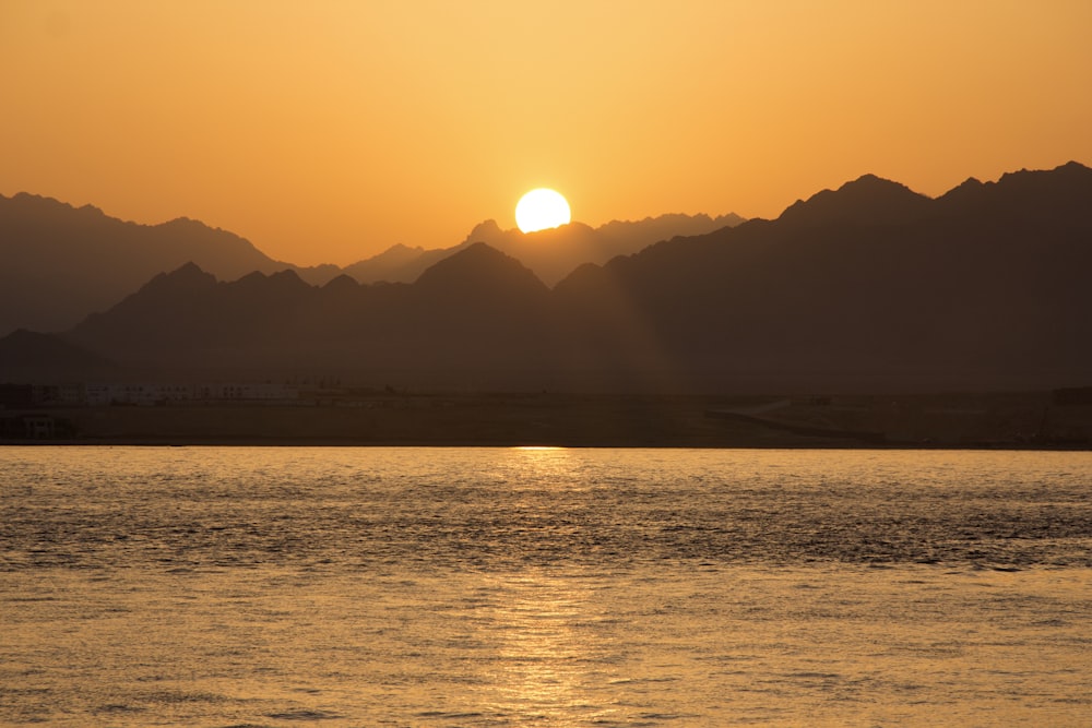 silhouette of mountain under sunrise