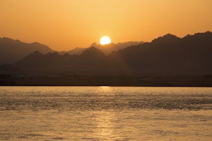 silhouette of mountain under sunrise