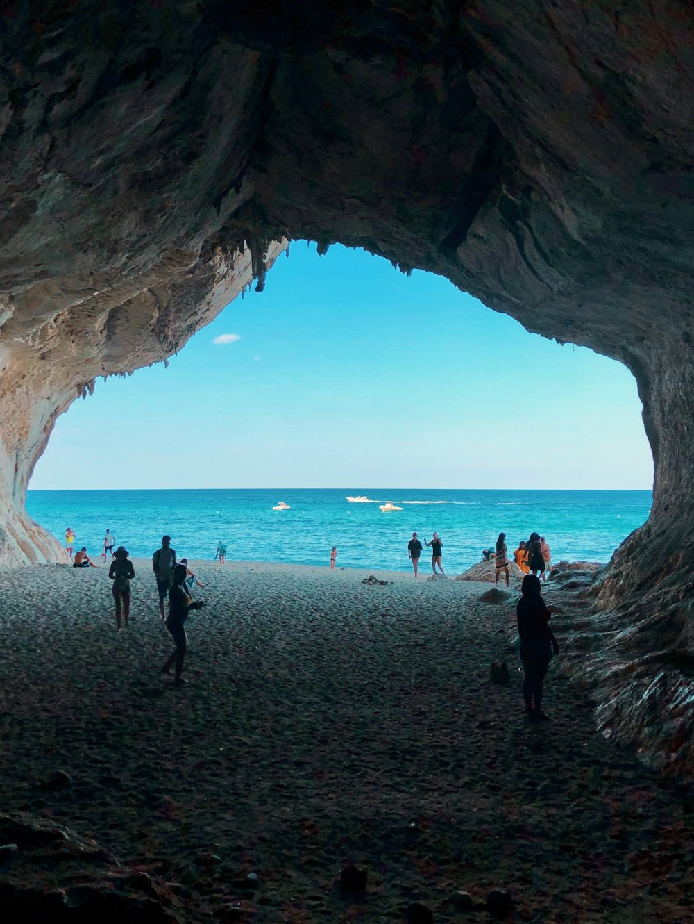 people standing front of sea at daytime