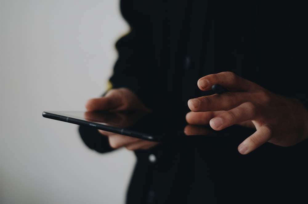 person holding tablet computer