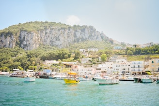 A vibrant coastal view of Ierapetra with turquoise waters and traditional Greek boats under a sunny sky.