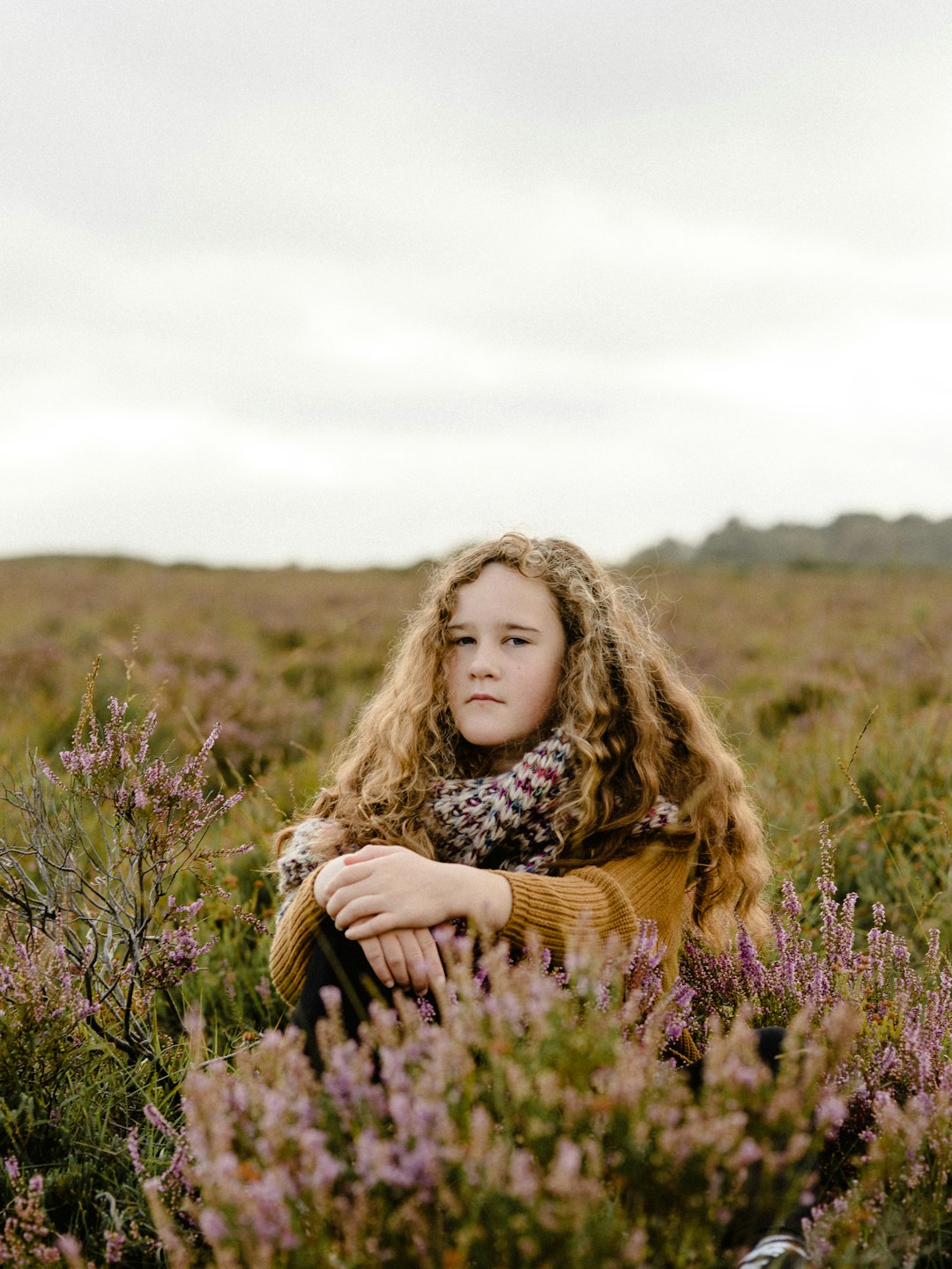 girl sits on grasses