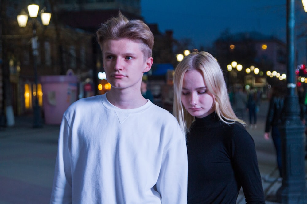 woman and man standing near pole