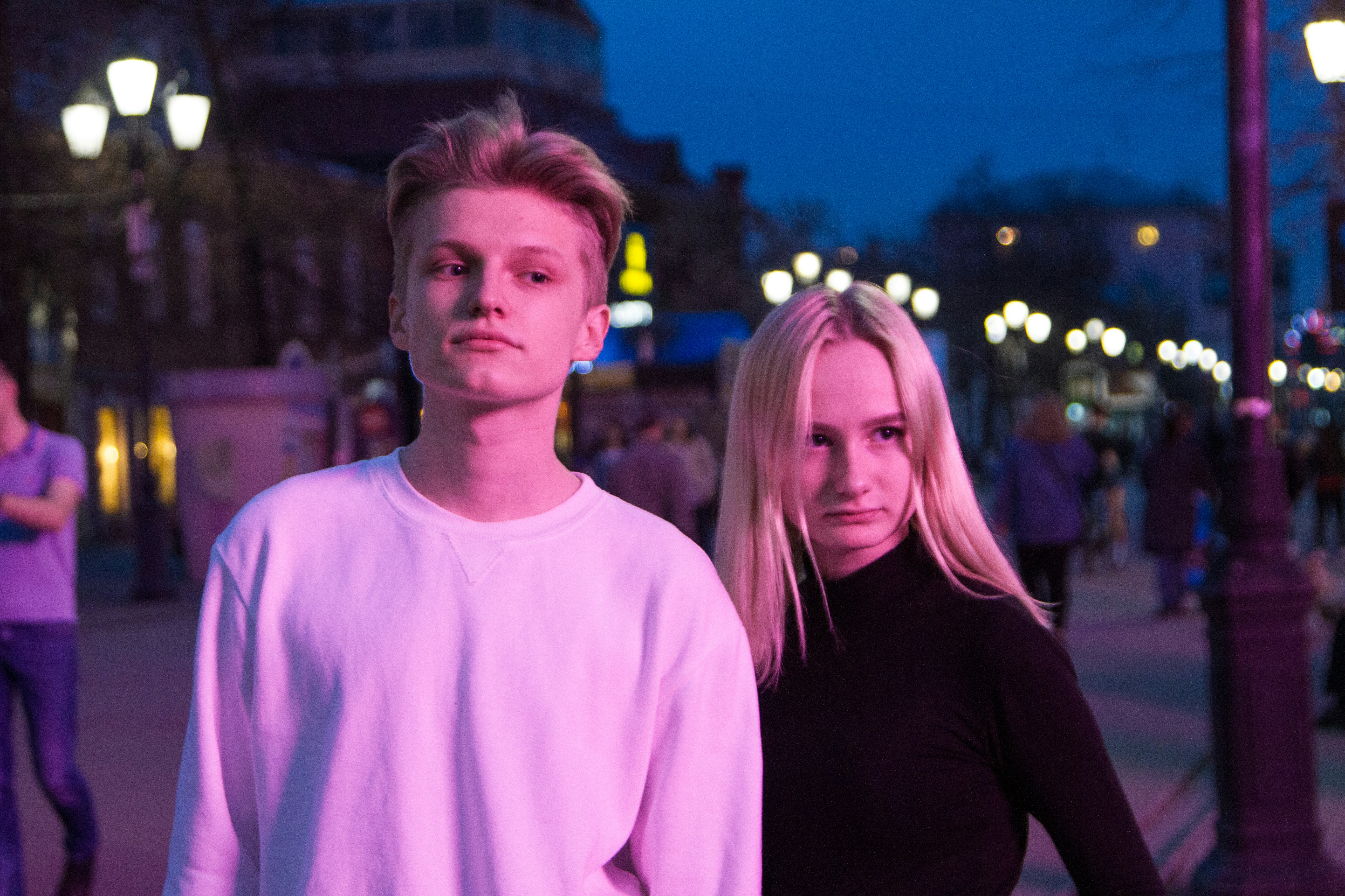 man and woman standing near people