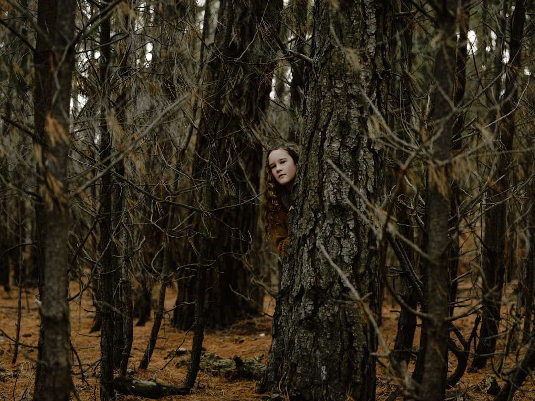 girl hiding on tree