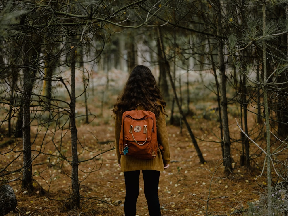 girl standing on forest