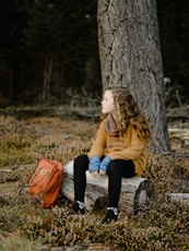 woman wearing brown jacket and black pants