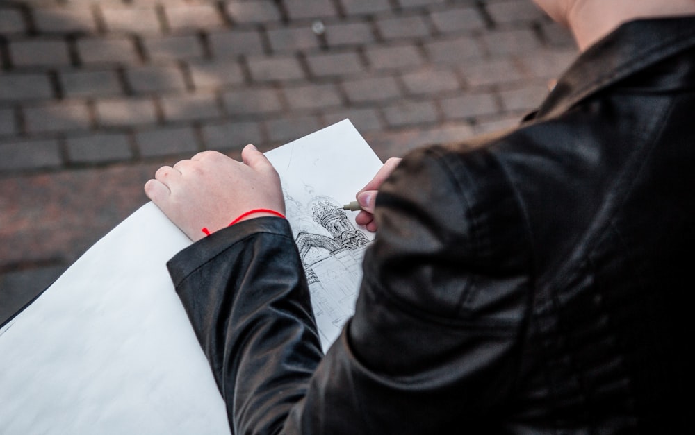 person wearing black leather jacket