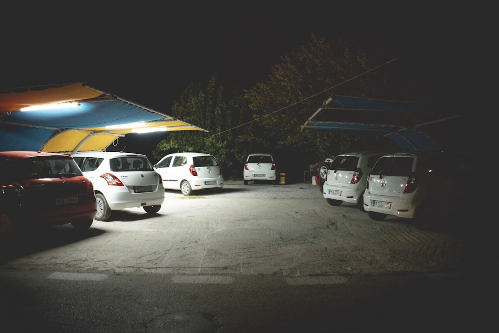 several vehicles parked beside sheds