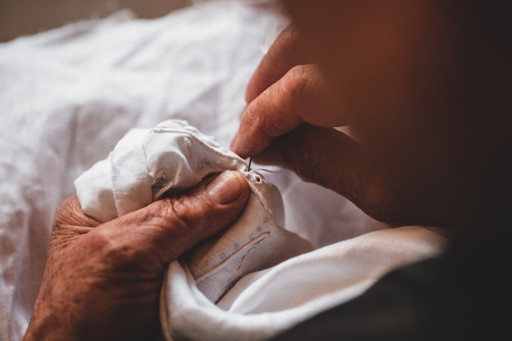 person sewing shirt