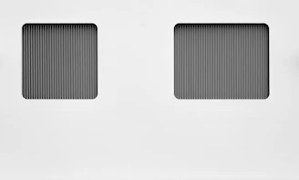 Square image showing a clean geometric split-screen layout with green and white sections.