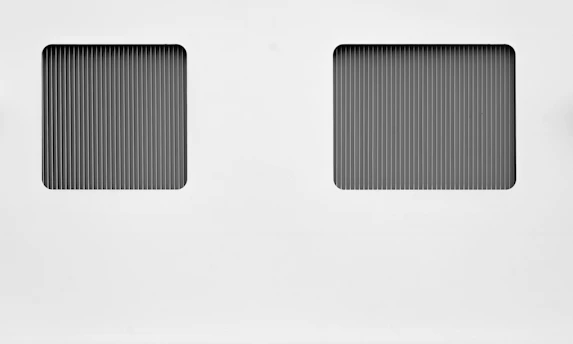 Square image showing a clean geometric split-screen layout with green and white sections.