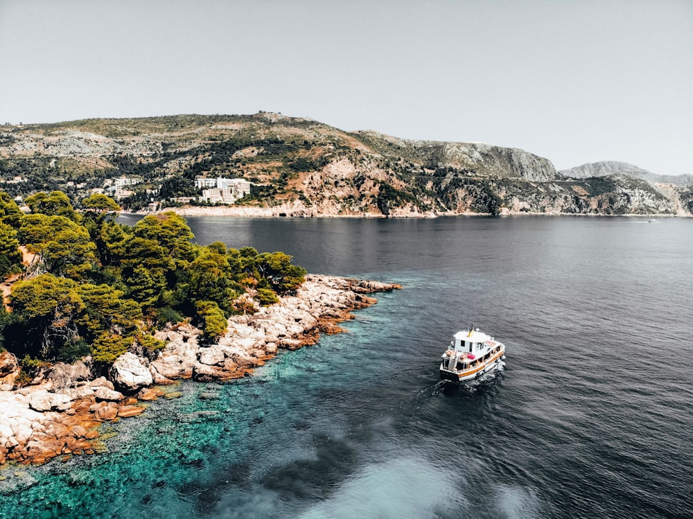 white boat on body of water during daytime