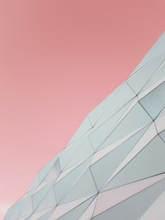 a building with a pink sky in the background