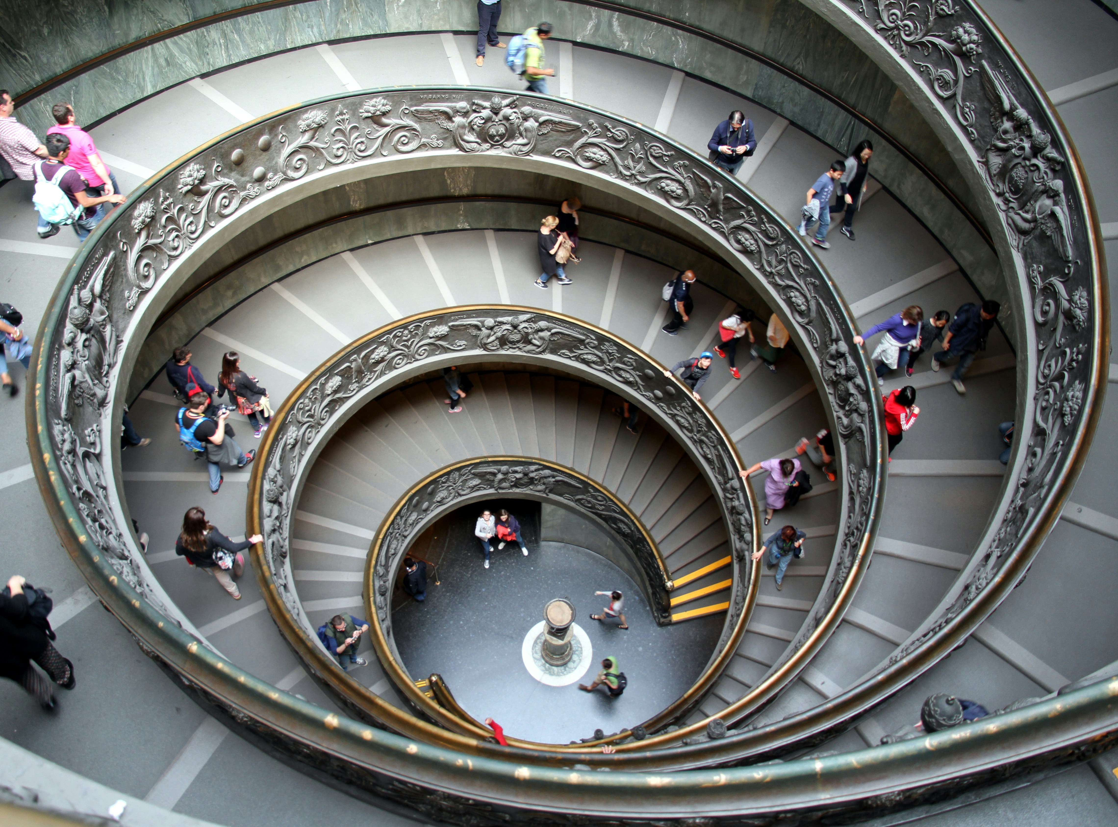 great photo recipe,how to photograph spiral stairs in museum of vaticano, italy, april 2015; people walking in spiral staircase