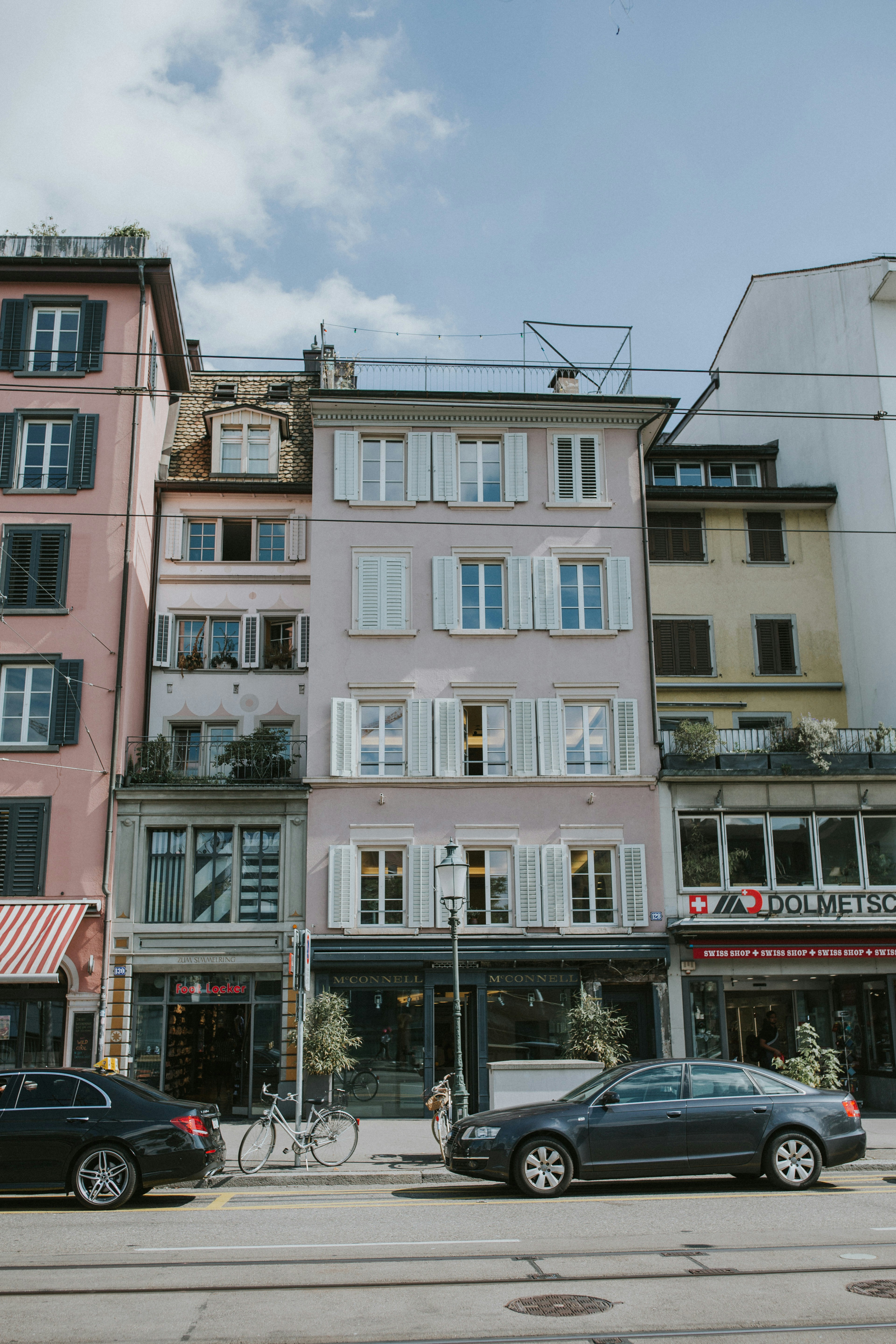 black sedan parked in front of building during daytime