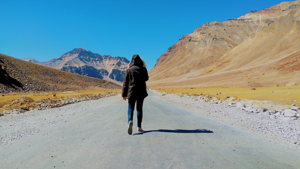 person walking on road at daytime