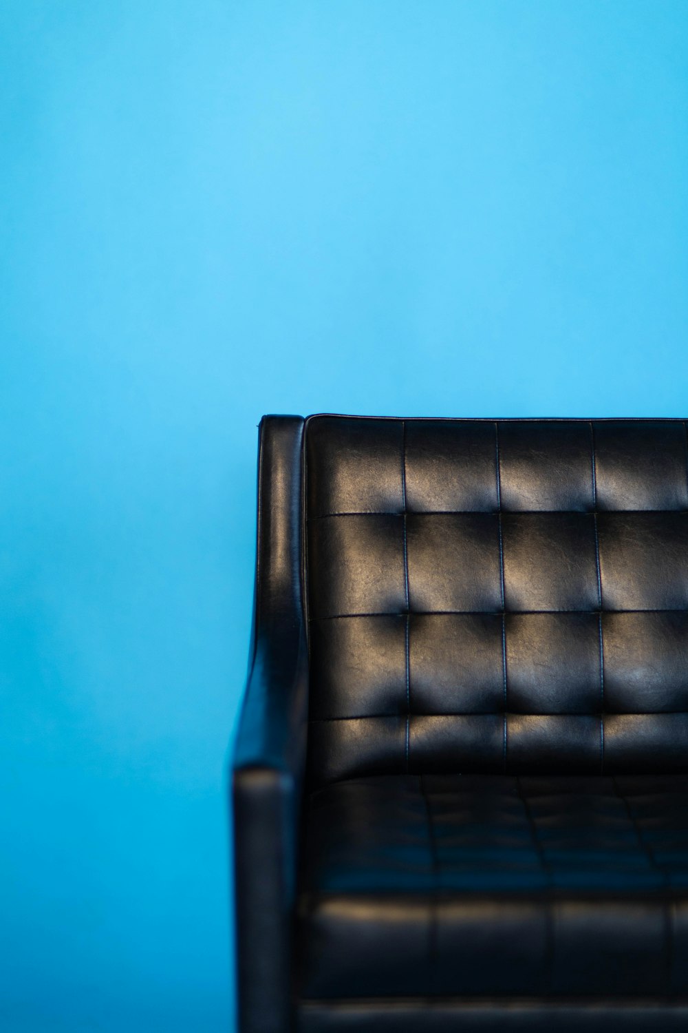 tufted black leather sofa