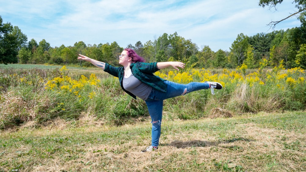 woman in green long-sleeved shirt raising left leg