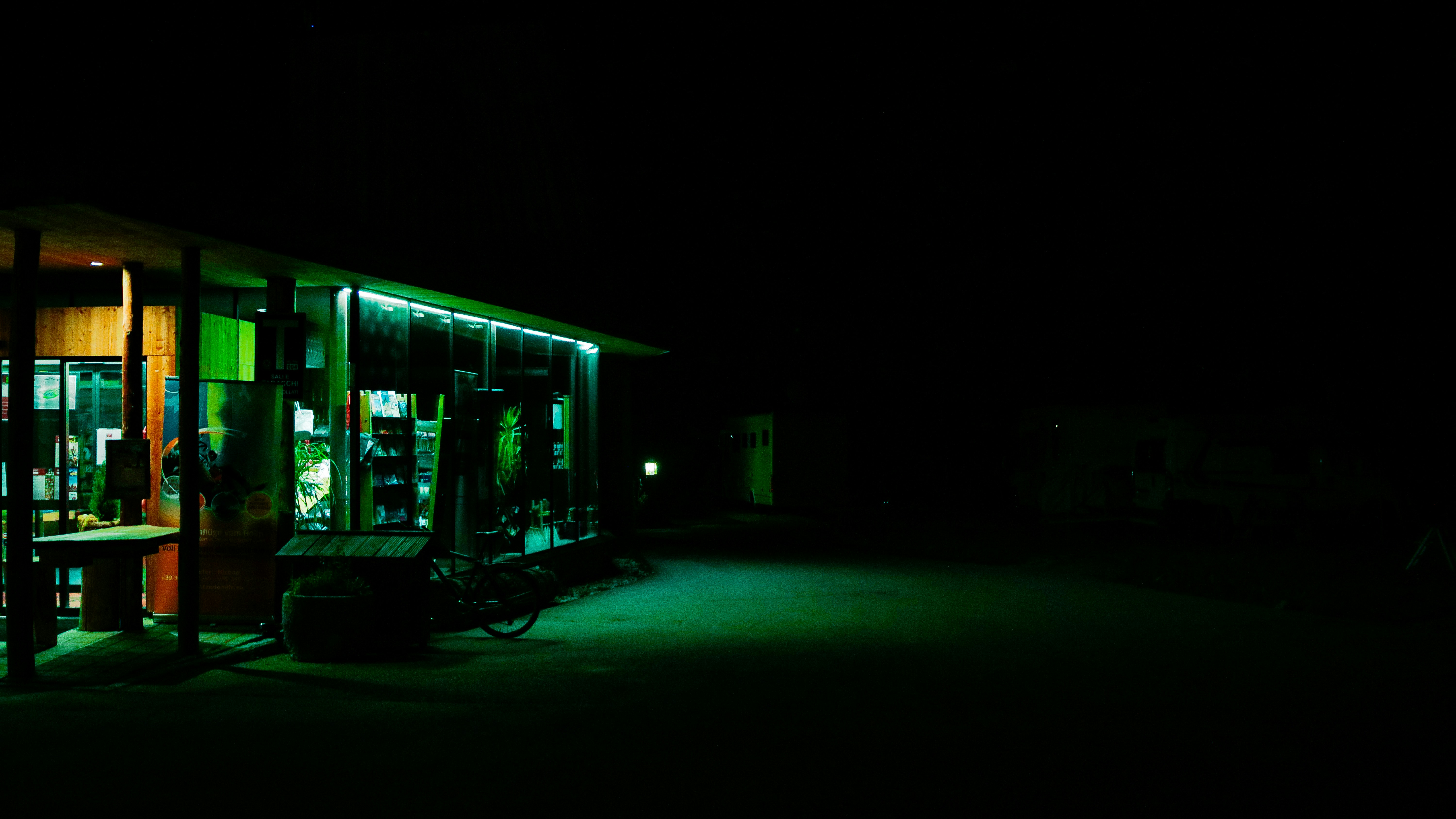 Electric pickup truck charging at a station at night