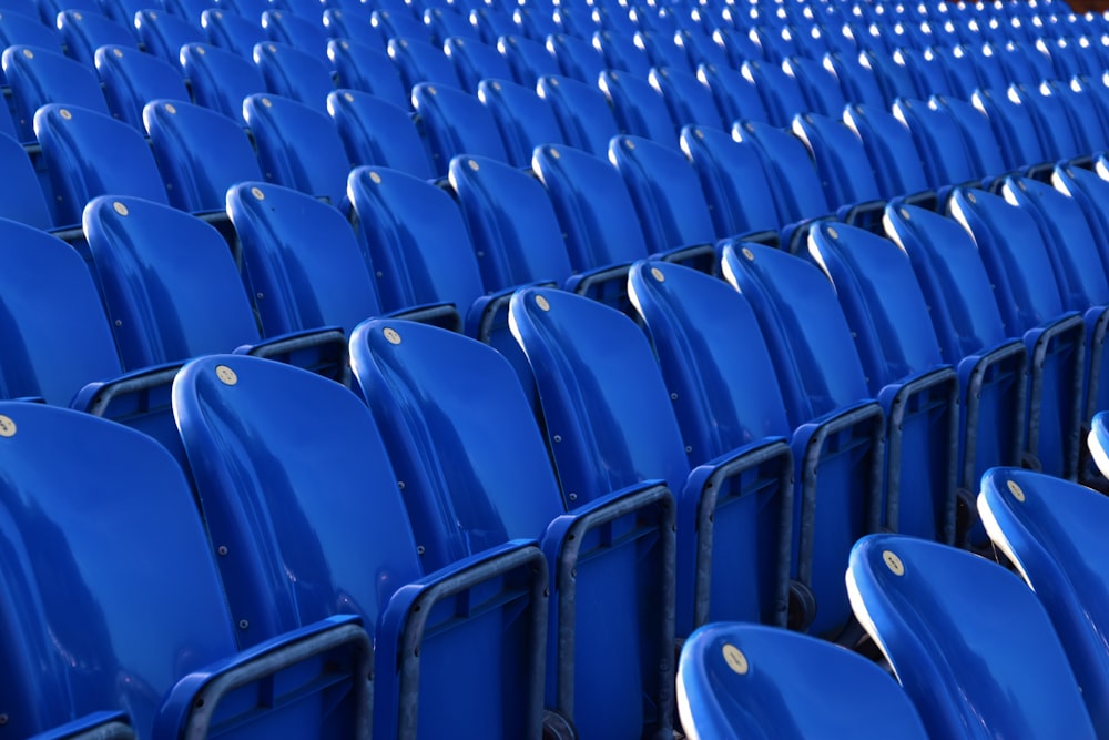 a row of blue chairs sitting next to each other