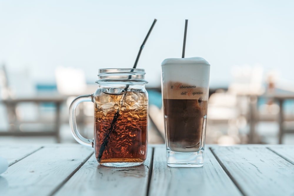 a glass of iced tea next to a jar of iced tea