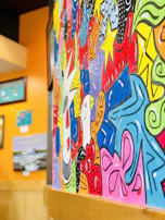 Artistic wall mural painted with vibrant colors enhancing a stylish room.