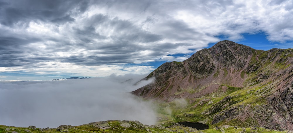 a view of a mountain covered in clouds