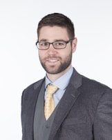 a man in a suit and tie posing for a picture