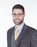 a vc investor in a suit and tie posing for a picture