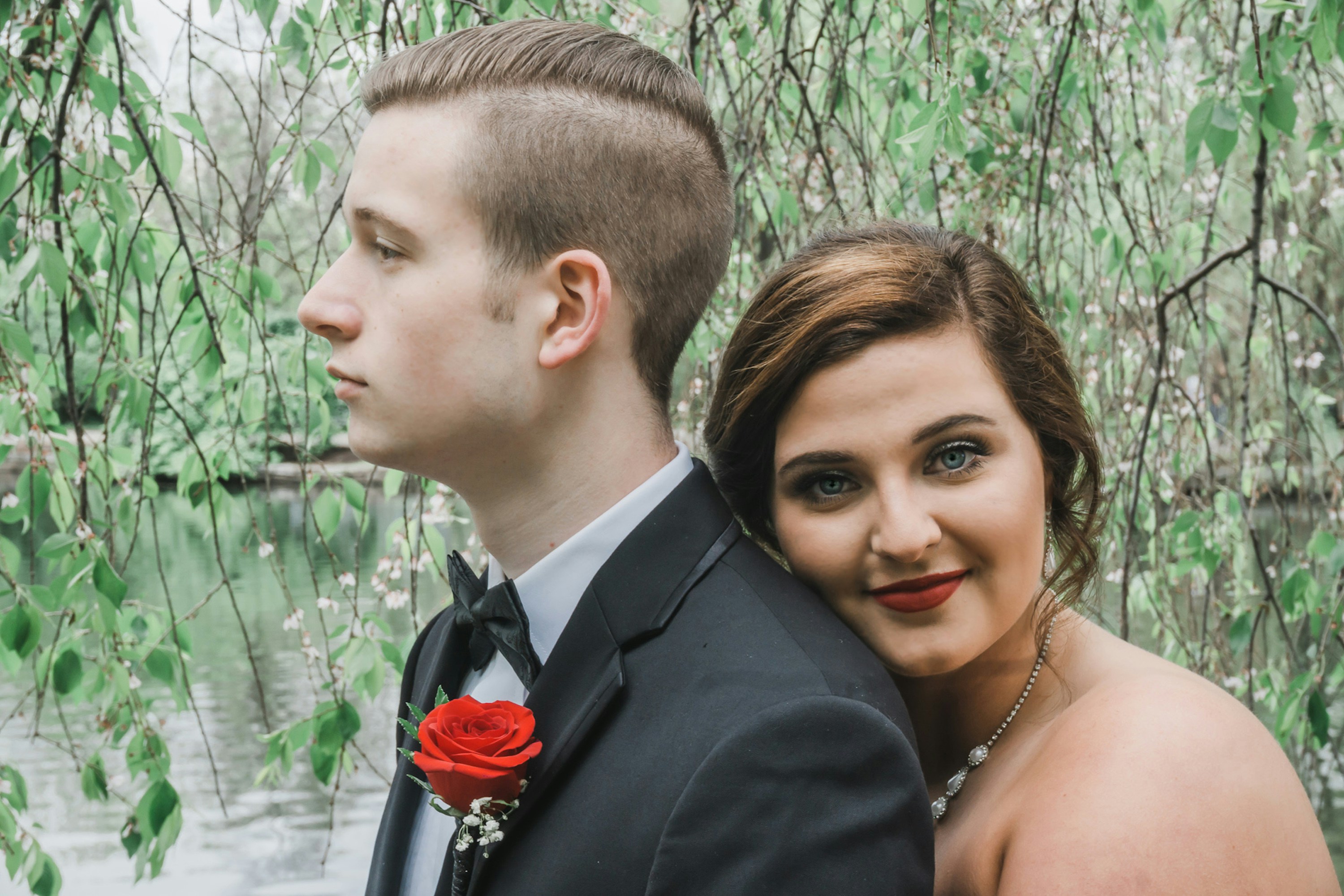 woman hugging man wearing black suit jacket