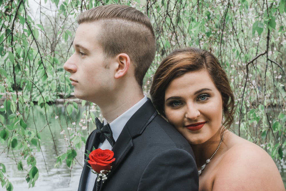 woman hugging man wearing black suit jacket