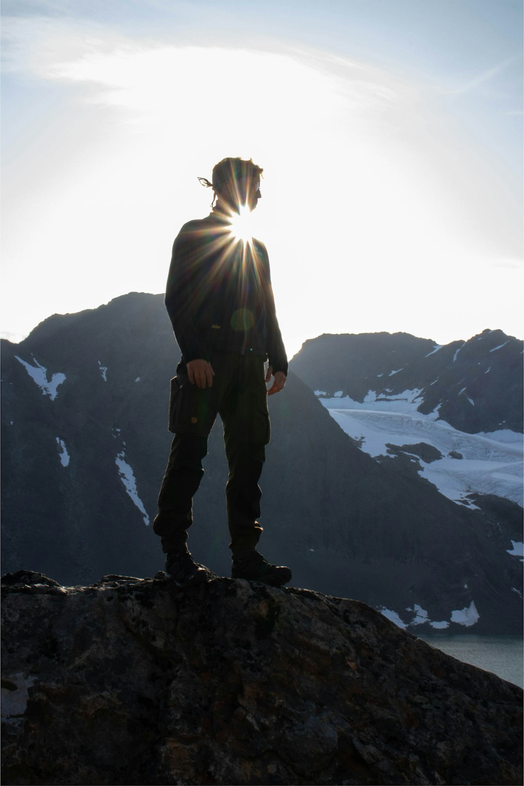 man stands on top of the cliff